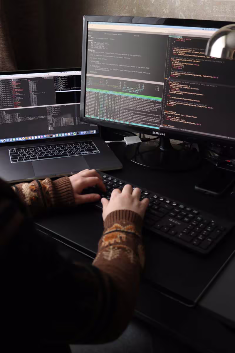 Developer working at a multi-screen workstation